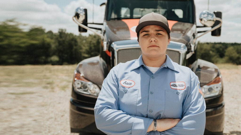 A woman standing in front of a truck