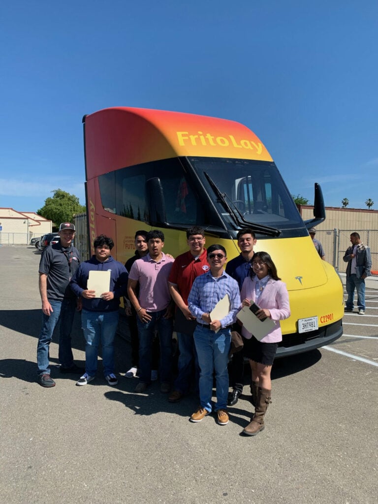 A group of people in front of a truck